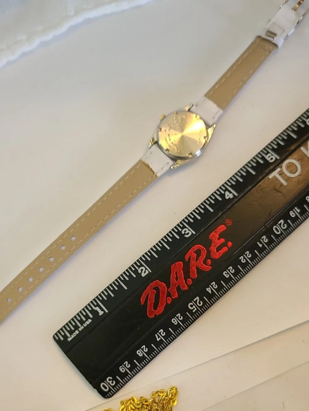 Seiko White Dial Watch with Gold Bezel and White Strap